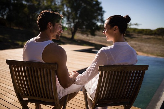 Affluent couple at Berkeley hillside terrace at sunset