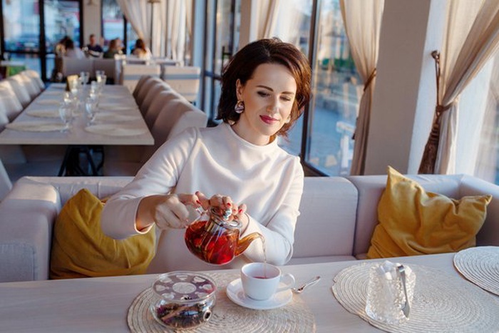 elegant woman enjoying afternoon tea