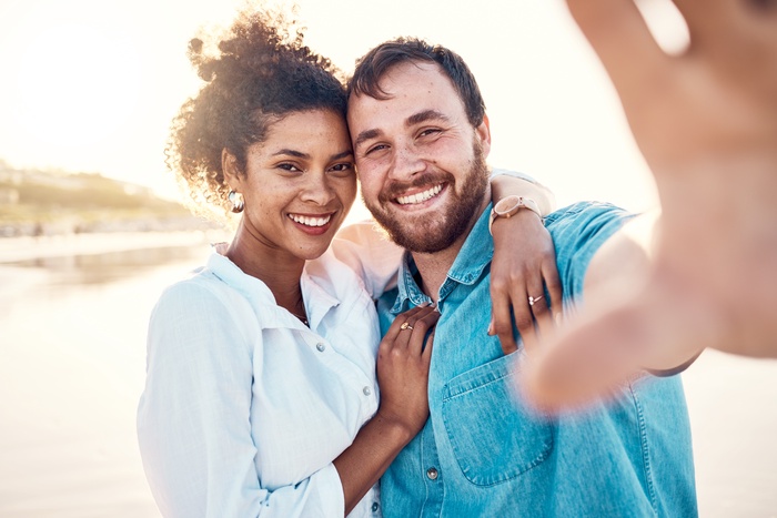 smile-and-happy-couple-on-beach-for-holiday