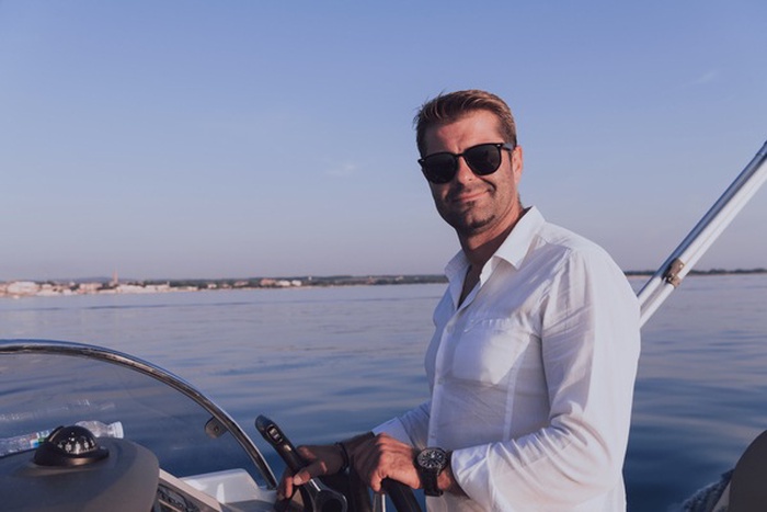 rich man driving a boat in North Miami