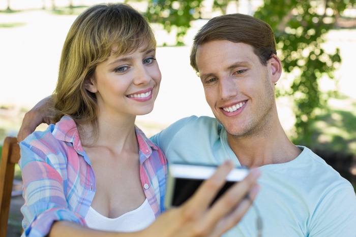 cute couple sitting on beach