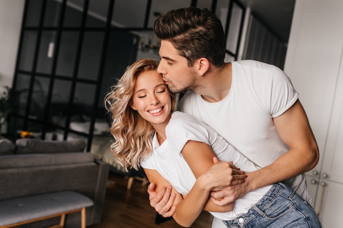 romantic guy kissing woman