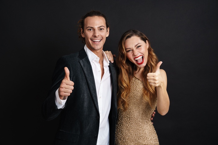 attractive smiling young couple celebrating