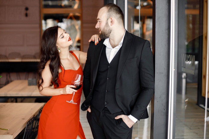 romantic couple standing restaurant date with glass wine