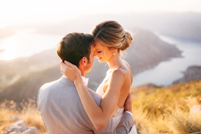 bride groom sitting top mount lovcen overlooking bay kotor smiling