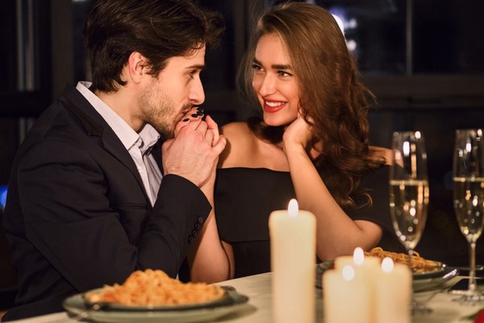 Elegant couple enjoying dinner at a rooftop restaurant in Monterrey