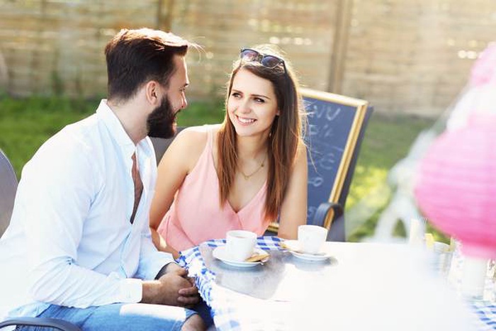 Mature men and women chat casually in upscale Parisian cafés