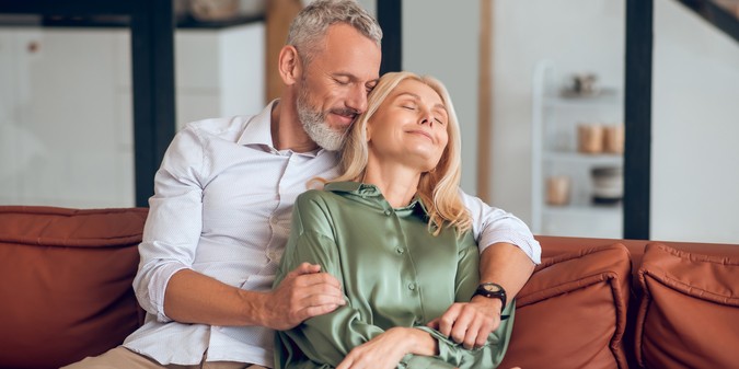 mature couple sitting on sofa