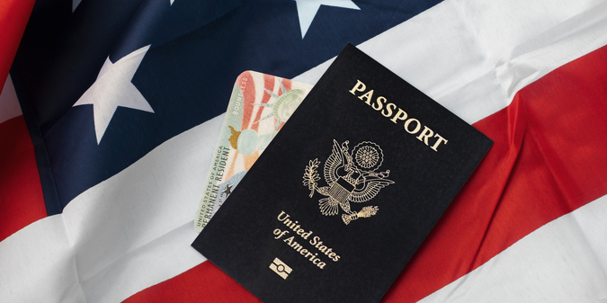 Flat lay green card and passport