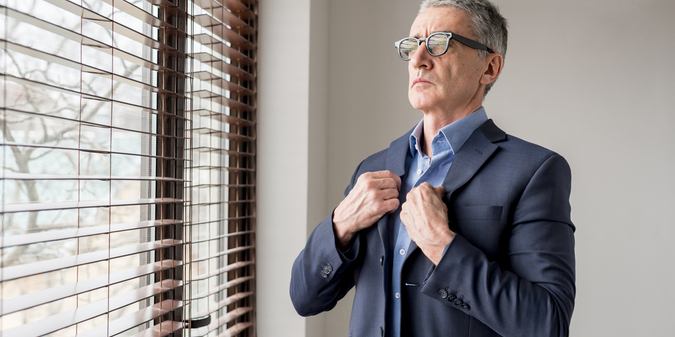 Mature men aged 40-55 adjusting their cuffs