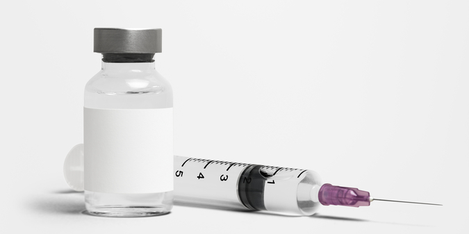 Blank white label on injection bottle glass vial with syringe