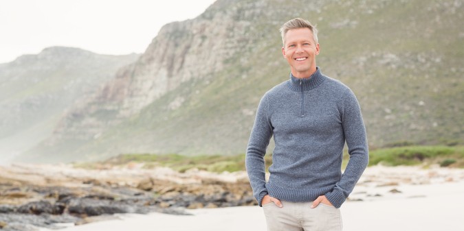 smiling man satnding shore