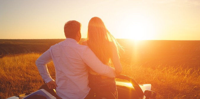 happy couple stay in the car