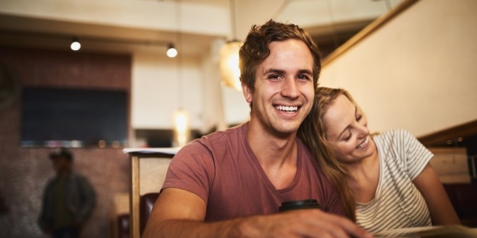 Happy couple on second date at cozy café table