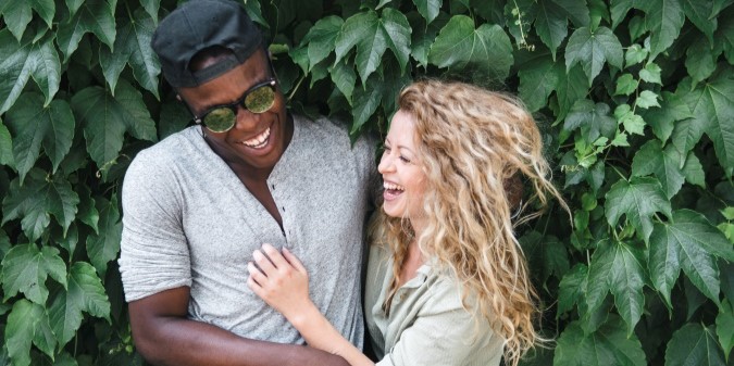 mixed race couple hugging in nature, happy couple