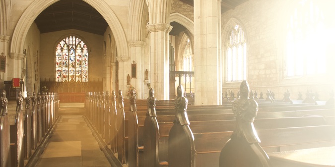 Empty benches in brightly lit church