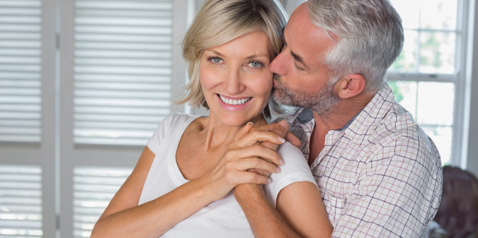 mature man kissing woman