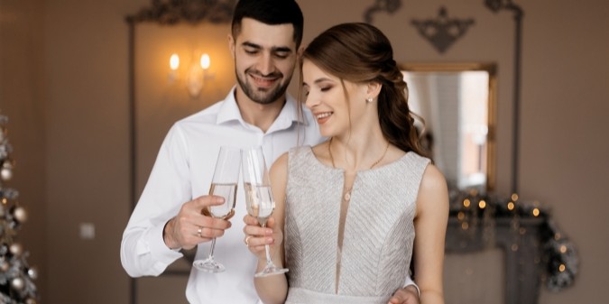 Loving couple embracing by Christmas tree