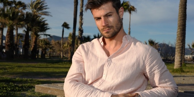 Handsome Latino man standing on the beach