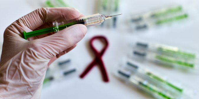 Syringes with anticoagulant and the red ribbon for thrombophilia awareness