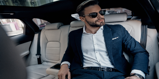 rich white man sitting in the car
