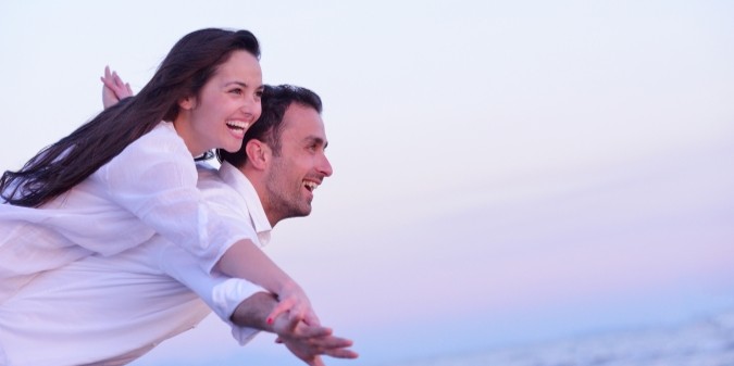 Happy couple enjoying a sunny day at the beach