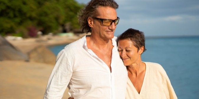 Happy mature couple enjoying time on the beach